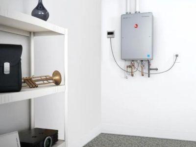 Compact wall-mounted tankless water heater in a utility space