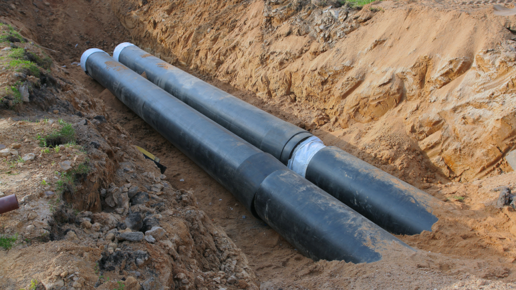 Sewer line installation in an excavated trench