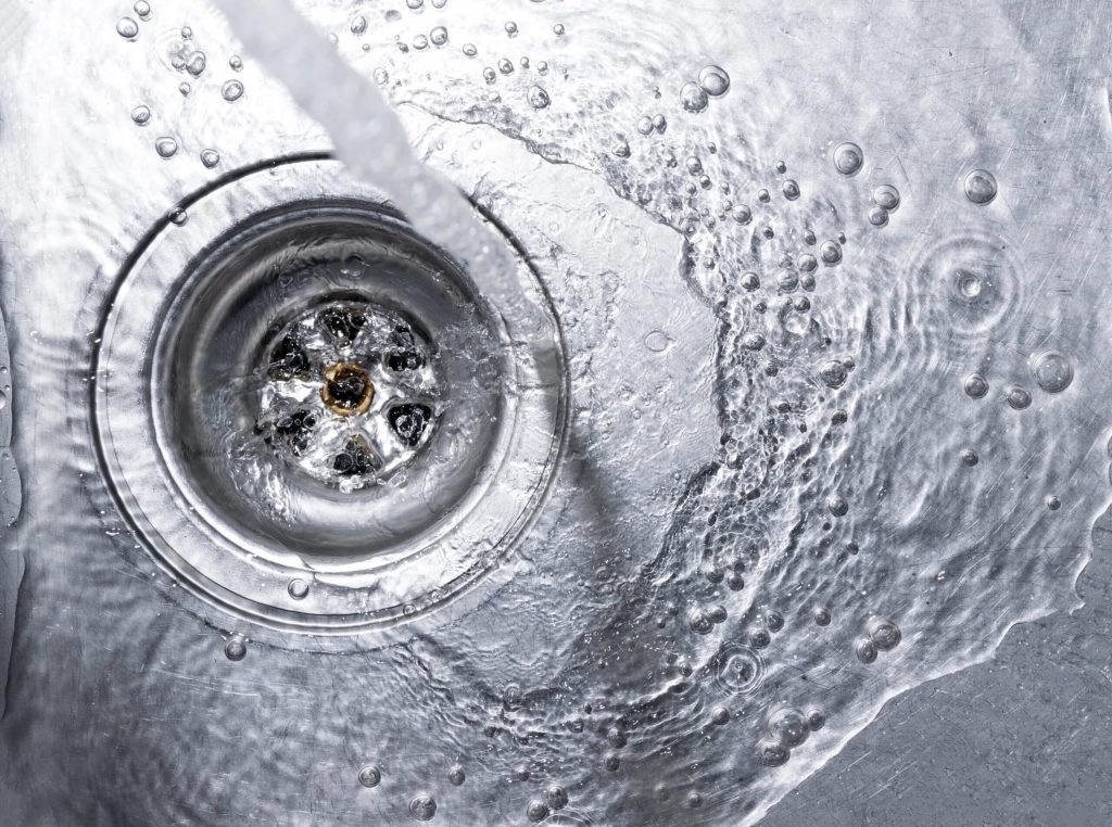 Water flowing freely through a clean metal drain