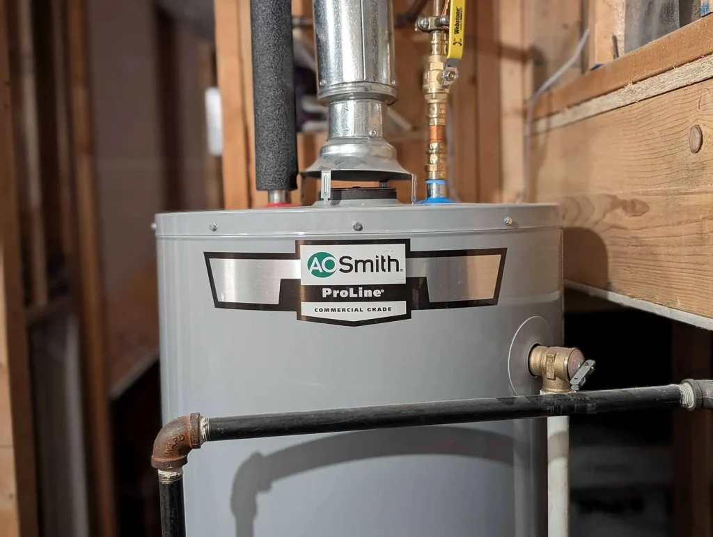 Installed gas storage water heater with venting and gas connection