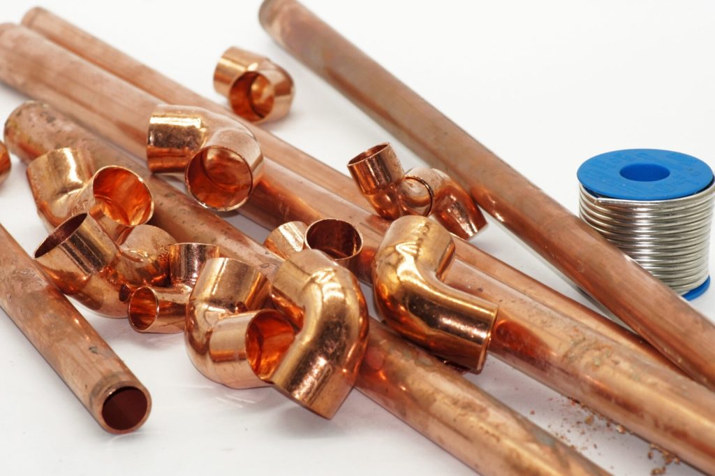 Copper pipe, elbows, fittings, and solder for plumbing installation
